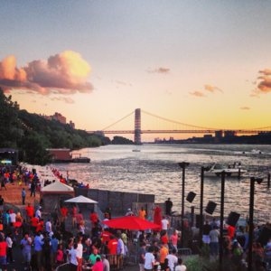 a lively private event is taking place at The Hudson as the river passes by and the George Washington Bridge is in the background