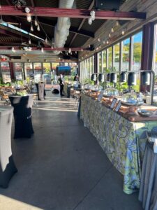 The Hudson's large event space with catering services set up, shining in the afternoon light